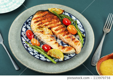 Plate of grilled salmon steak. 113970738