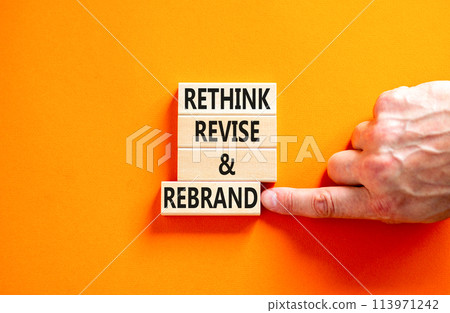 Rethink revise rebrand symbol. Concept word Rethink Revise and Rebrand on beautiful block. Beautiful orange background. Business brand motivational rethink revise rebrand concept. Copy space. 113971242