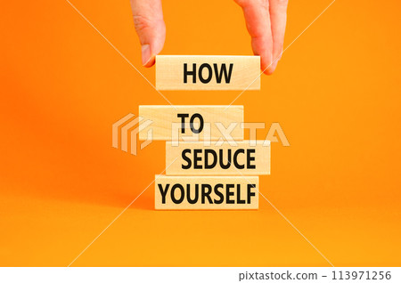 How to seduce yourself symbol. Concept word How to seduce yourself on wooden blocks. Businessman hand. Beautiful orange table orange background. Business and how to seduce yourself concept. Copy space 113971256