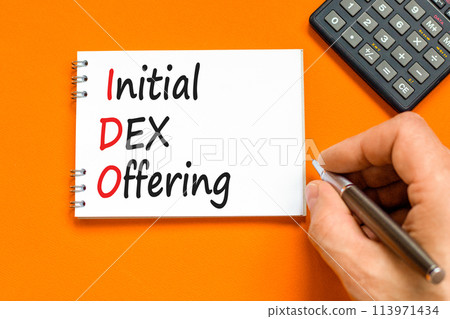 IDO initial DEX offering symbol. Concept words IDO initial DEX offering on beautiful white note. Beautiful orange background. Businessman hand. Business IDO initial DEX offering concept. Copy space. 113971434