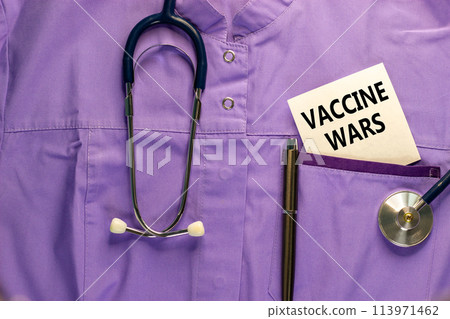 COVID-19 vaccine wars symbol. Medical uniform, white card with words 'vaccine wars', metalic pen and stethoscope. Beautiful white background. COVID-19 vaccine wars concept. COVID-19 vaccine wars symbol. Medical uniform, white card with words 'vaccine wars', metalic pen and stethoscope. Beautiful white background. COVID-19 vaccine wars concept. 113971462