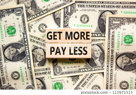 Get more pay less symbol. Concept words Get more pay less on wooden blocks on a beautiful background from dollar bills. Business Get more pay less concept. Copy space. Get more pay less symbol. Concept words Get more pay less on wooden blocks on a beautiful background from dollar bills. Business Get more pay less concept. Copy space. 113971515