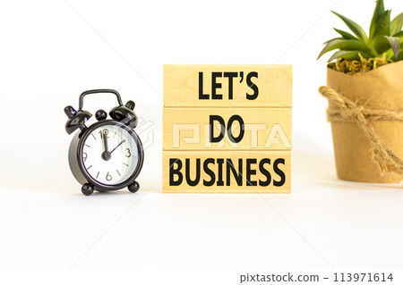 let is do business symbol. Concept words let is do business on beautiful wooden blocks. Beautiful white table white background. Black alarm clock. let is do business concept. Copy space. 113971614