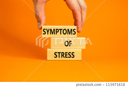 Symptoms of stress symbol. Concept words Symptoms of stress on wooden blocks. Beautiful orange table orange background. Doctor hand. Psychological business and Symptoms of stress concept. Copy space. 113971618
