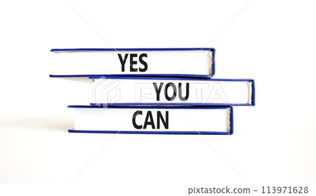 Motivational and Yes you can symbol. Concept words Yes you can on beautiful books. Beautiful white table background. Business motivational and Yes you can concept. Copy space. 113971628