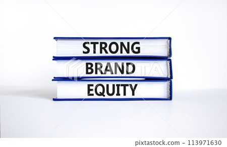 Strong brand equity symbol. Concept words Strong brand equity on books on a beautiful white table white background. Business, finacial and strong brand equity concept. 113971630