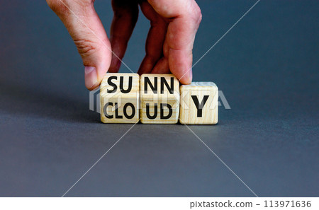 Sunny or cloudy symbol. Concept word Sunny or Cloudy on wooden cubes. Beautiful grey table grey background. Businessman hand. Business lifestyle and sunny or cloudy concept. Copy space. 113971636