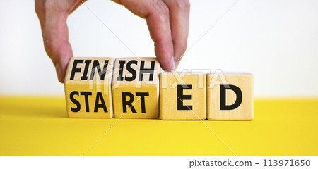 Started and finished symbol. Businessman turns beautiful wooden cubes and changes word Started to Finished. Beautiful yellow table white background. Business started and finished concept. Copy space. Started and finished symbol. Businessman turns beautiful wooden cubes and changes word Started to Finished. Beautiful yellow table white background. Business started and finished concept. Copy space. 113971650