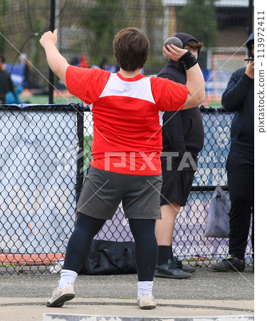 Shot put thrower ready to throw in the circle 113972411