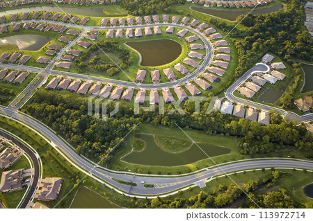 Aerial view of tightly located family houses in Florida closed suburban area. Real estate development in american suburbs 113972714