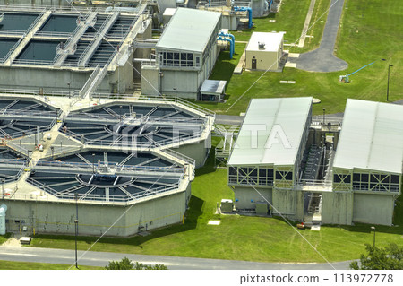 Aerial view of modern water cleaning facility at urban wastewater treatment plant. Purification process of removing undesirable chemicals, suspended solids and gases from contaminated liquid 113972778