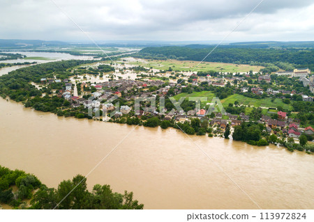Aerial view of Dnister river with dirty water and  flooded houses in Halych town, western Ukraine. 113972824