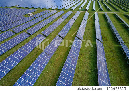Aerial view of big sustainable electric power plant with many rows of solar photovoltaic panels for producing clean electrical energy. Renewable electricity with zero emission concept 113972825