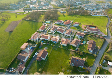Aerial view of residential houses in green suburban rural area Aerial view of residential houses in green suburban rural area 113972840