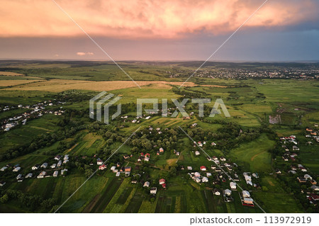 Aerial view of residential houses in suburban rural area at sunset 113972919