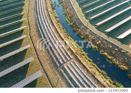 Aerial view of large sustainable electrical power plant with rows of solar photovoltaic panels for producing clean ecological electric energy. Renewable electricity with zero emission concept 113972993