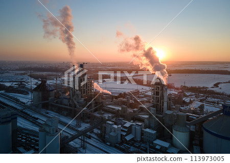 Aerial view of cement factory tower with high concrete plant structure at industrial production area at sunset. Manufacturing and global industry concept Aerial view of cement factory tower with high concrete plant structure at industrial production area at sunset. Manufacturing and global industry concept 113973005