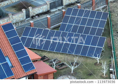 Private home roof covered with solar photovoltaic panels for generating of clean ecological electric energy in suburban rural town area. Concept of autonomous house Private home roof covered with solar photovoltaic panels for generating of clean ecological electric energy in suburban rural town area. Concept of autonomous house 113973036