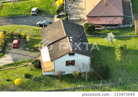 Aerial view of residential houses in green suburban rural area 113973049