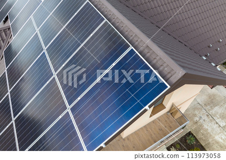 Aerial view building roof with rows of blue solar photovoltaic panels for producing clean ecological electric energy. Renewable electricity with zero emission concept 113973058