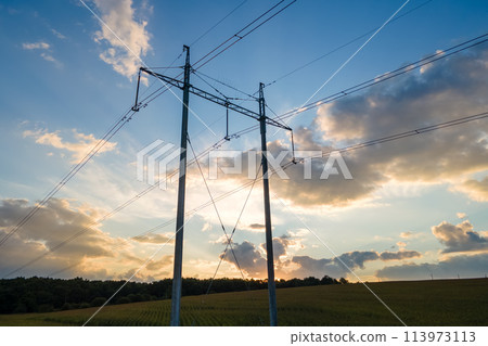 Dark silhouette of high voltage tower with electric power lines at sunrise. Dark silhouette of high voltage tower with electric power lines at sunrise. 113973113