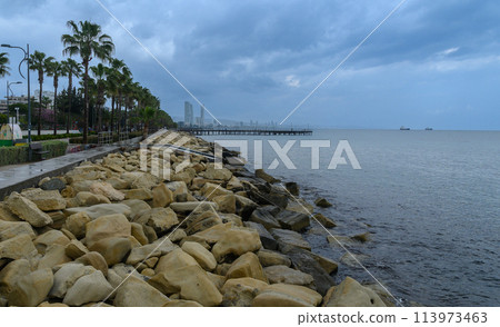 Cyprus, Limassol, Molos seafront promenade and scenic views of Olimpia coast and financial center. 113973463