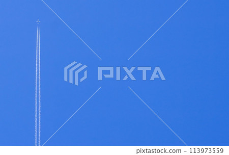 Passenger plane with reverse wake flies high in the blue sky 113973559
