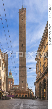 Bologna renowned Asinelli Tower reaches for the sky, captured in a vertical shot from street level 113973635