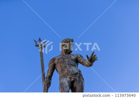 The bronze Neptune reaches towards the heavens, trident in hand, at Bologna Fountain of Neptune 113973640