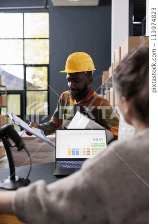 African american employee discussing merchandise checklist with storehouse supervisor, preparing customers orders for delivery. Diverse storage room team working at goods inventory in warehouse African american employee discussing merchandise checklist with storehouse supervisor, preparing customers orders for delivery. Diverse storage room team working at goods inventory in warehouse 113974823