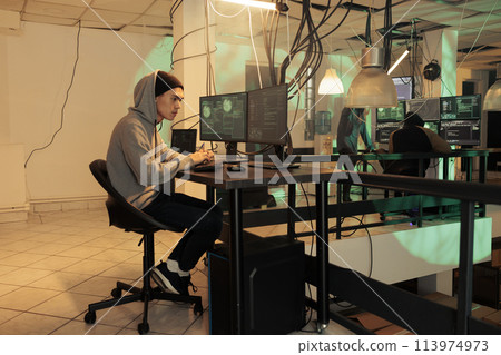 Asian man committing computer fraud on network, thief hacking system and planting malware, stealing database information. Online criminal cracking online password, writing encryption at night. Asian man committing computer fraud on network, thief hacking system and planting malware, stealing database information. Online criminal cracking online password, writing encryption at night. 113974973