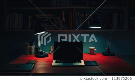 A desk with laptop in a dark space with minimal spotlighting, Workspace with laptop in the dark 113975206