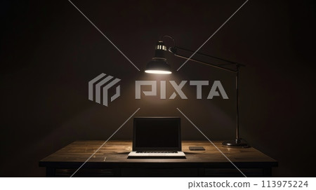 A desk with laptop in a dark space with minimal spotlighting, Workspace with laptop in the dark 113975224