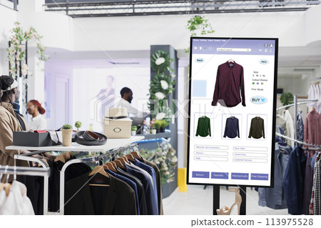 Touch screen monitor kiosk service, modern fashion collection and products on interactive board in mall store. Electronic self ordering display of online clothes shop, business concept. 113975528