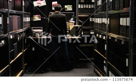 Law agent working on crime, looking at surveillance footage for suspect identification. Professional detective gathering intelligence to build strong case against culprit, secret mission. 113975674