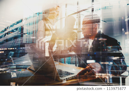 Business people in office work together during a meeting Business people in office work together during a meeting 113975877