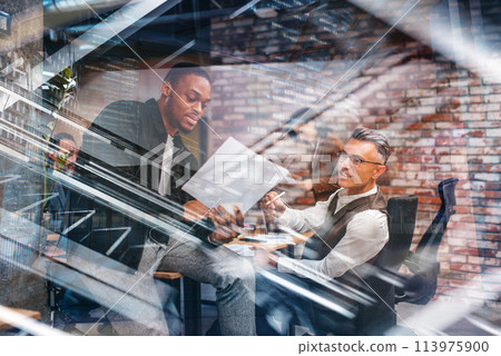 Business people in office work together during a meeting 113975900