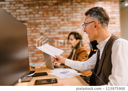 Business people in office work together during a meeting 113975908