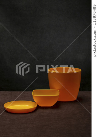 A set of yellow plastic dishes A set of yellow plastic dishes 113976499