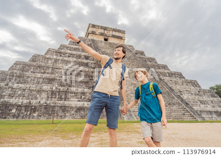 Father and son tourists observing the old pyramid and temple of the castle of the Mayan architecture known as Chichen Itza these are the ruins of this ancient pre-columbian civilization and part of Father and son tourists observing the old pyramid and temple of the castle of the Mayan architecture known as Chichen Itza these are the ruins of this ancient pre-columbian civilization and part of 113976914