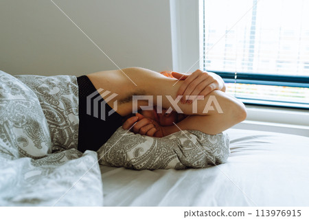 morning, young woman waking up in bed with natural hair under arms morning, young woman waking up in bed with natural hair under arms 113976915