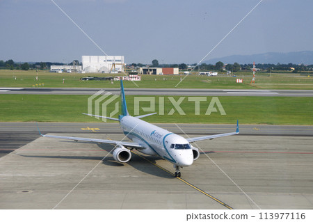 TURIN, ITALY - 15 SEP 2019: Aircraft parked at the gate at the Tamac of Turin airport waiting for passengers 113977116