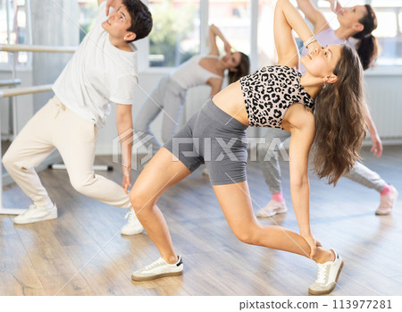 Girl with team of young like-minded people learn to dance modern dances 113977281