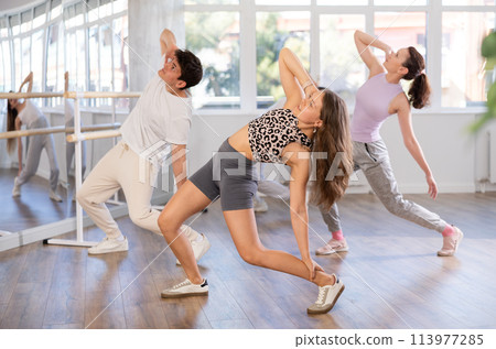 Young girl practicing hip-hop dance in training hall in group 113977285