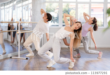 Young girl practicing hip-hop dance in training hall in group 113977291