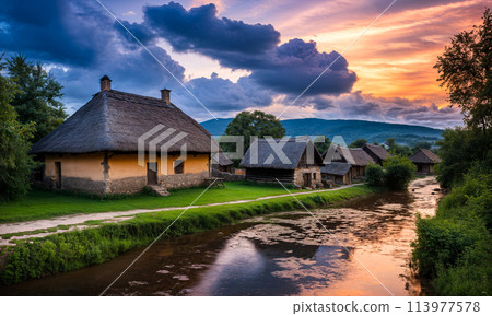 Panoramic top view of an old small abandoned ruined village on the hills with thatched roof huts at sunset with clouds in the sky Panoramic top view of an old small abandoned ruined village on the hills with thatched roof huts at sunset with clouds in the sky 113977578