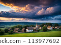 Panoramic top view of an old small abandoned ruined village on the hills with thatched roof huts at sunset with clouds in the sky 113977692