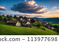 Panoramic top view of an old small abandoned ruined village on the hills with thatched roof huts at sunset with clouds in the sky 113977698