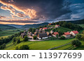 Panoramic top view of an old small abandoned ruined village on the hills with thatched roof huts at sunset with clouds in the sky 113977699