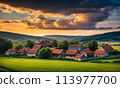 Panoramic top view of an old small abandoned ruined village on the hills with thatched roof huts at sunset with clouds in the sky 113977700